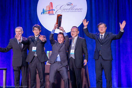excellence awards winners holding trophy