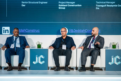 panel of men sitting on stage